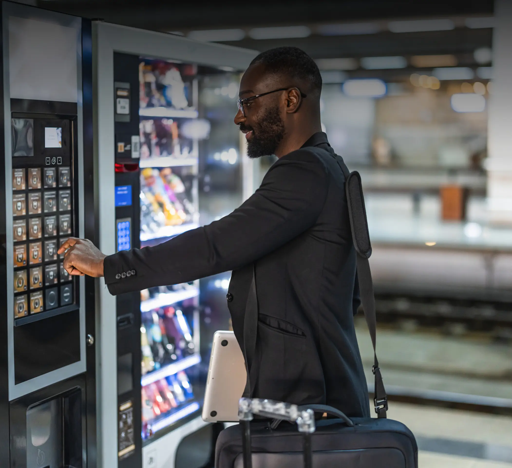 Businessman selecting snack from vending machine